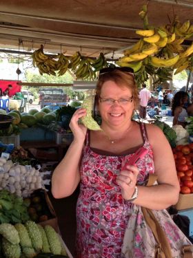 Belize market with woman on banana phone – Best Places In The World To Retire – International Living